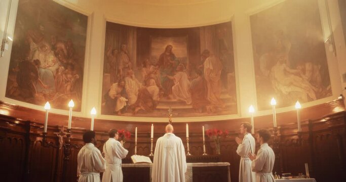 In Grand Old Church at the Altar Ministers Lead The Eucharist, Sacred Christian Ceremony. Holy Communion, Divine Mass, Lord's Supper. Pan Camera Movement Showing Painting of Jesus Christ on Ceiling