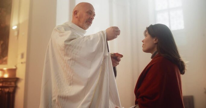 In Church Ceremony of Holy Communion, Eucharist or Last Supper: Christian Minister Breaking bread, Giving it to Parishioner, act of Unity with Jesus Christ, Saviour Who Sacrificed Himself for People