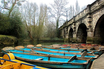 Wooden boats and landscape with bridge and arches