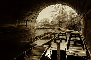 Parked boats under bridge nice stone arch - sephia