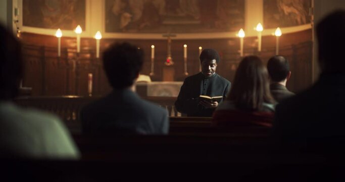 In Christian Church: Portrait of Minister Leading Congregation In Prayer, Reads From Holy Book, The Bible, Gospel of Jesus. Priest Providing Guidance, Belief, Hope, Faith to People. Cinematic Light