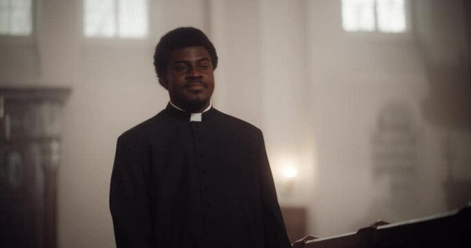 In Church Priest Walks in Contemplation, Trying to Understand The Holy Book, the Bible, Thinking about Gospels, Teaching the Word of Lord and Savior Jesus Christ. Christian Preacher Thinks of Sermon 