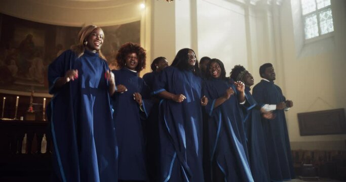 Black Christian Gospel Singers in Church Clapping and Stomping, Praising Lord Jesus Christ. Warm Atmosphere in Church Thanks to Energetic Choir Singing Uplifting Music with Emotions and Happiness