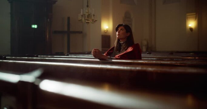 Portrait of a Young Woman Praying in the Majestical Old Church. Parishioner Feeling the Connection to the Divinity. Hope and Belief in Salvation through Goodness, Kindness. Contemplation in Cathedral