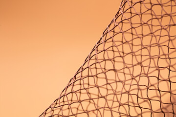 Brown fishing net, on soft brown background