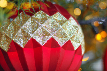 textured geometric red and silver color ornate on Christmas tree, close up. New Year, festive decor