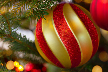 textured red and gold color ornate on Christmas tree, close up. New Year, festive decor