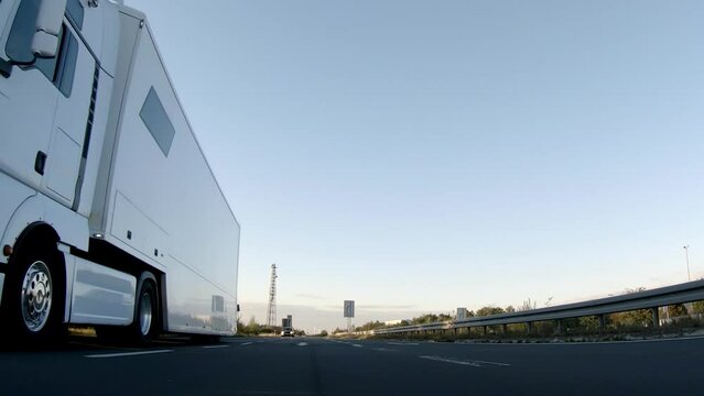 Semi trucks van cargo and parcel delivery driving on a highway. White Van delivers goods in early hours of the Morning 