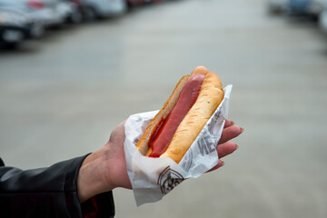 close up of hotdog in hand