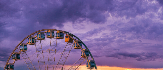 Helsinki, Finland. Very Peri Cloudy Sky Above Ferris Wheel. Light Violet Colors. Bright Dramatic...