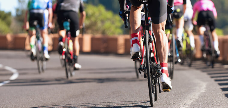 Group of cyclist at professional race, cyclists in a road race stage. Climbing the hill