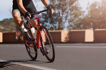 Fototapeta premium Road bike cyclist man cycling, athlete on a race cycle. Leaning into a corner