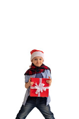 Adorable little happy kid in a Santa Clause hat and a red scarf  holds a christmas gift in his hands and smiles.  isolated on white background