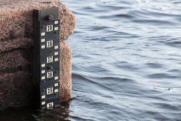 Tide gauge mounted on granite bank, Neva river, Saint-Petersburg