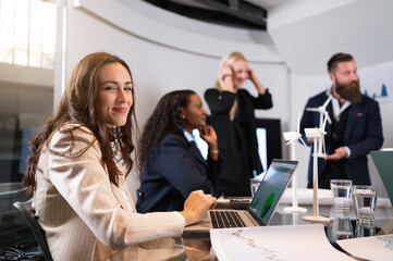 Portrait young businesswoman working on a project of renewable energy. Sustainability and teamwork concept.
