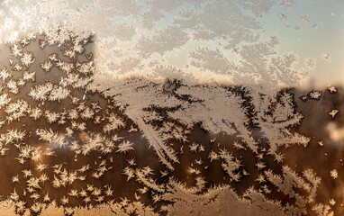 Frosty drawing on the window close-up in winter