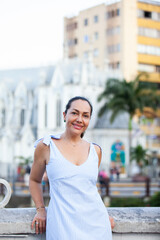 Beautiful tourist woman at the Ortiz Bridge with La Ermita church on background in the city of Cali in Colombia