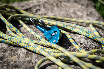 Rock climbing assisted belaying device and a green rope