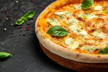 four cheese pizza, homemade italian pizza. Pizza on rustic black background. Traditional italian cuisine. place for text, top view