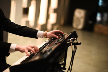 Musician's hands playing a keyboard