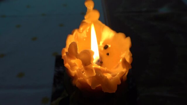 A Christmas candle burns with a magical fire during Christmas Eve
