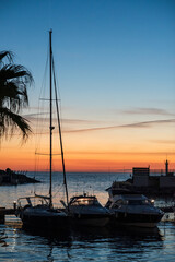 Fototapeta na wymiar Sunset over the sea with sailboat silhouette