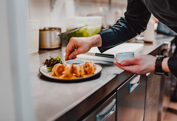 man chef cooking tasty shrimp on kitchen