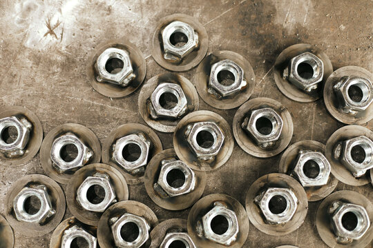From above close-up shot of nuts welded with flanges