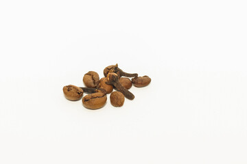 Photo of coffee bean and clove on white background