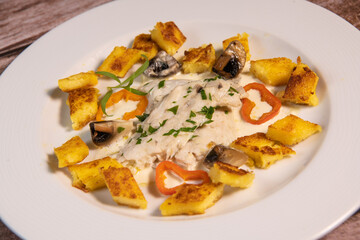 Recipe for sea bass fillet with fried polenta and white wine sauce. High quality photo