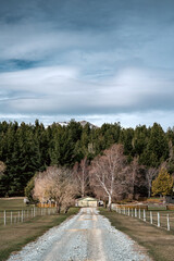 Scenic view of Lake Tekapo east bank. Beautiful view driving along the Lilybank Road from Lake Tekapo Park towards Motuariki View Point. Farm house can be seen near the view point.