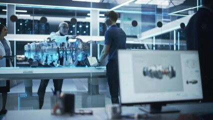 Middle Aged Engineer, Project Manager and Team of Scientists Collaborate on a New Type of Electric Turbine Engine. Rack Focus Moves to Industrial Designer Working in 3D CAD Software on Computer.