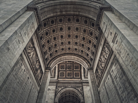 View underneath triumphal Arch, in Paris, France. Architectural details of the famous Arc de triomphe landmark.