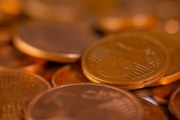 A pile of change on the table. Many euro coins in one stack. The concept of a monetary crisis in the country. Selective soft focus