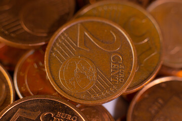 A pile of change on the table. Many euro coins in one stack. The concept of a monetary crisis in the country. Selective soft focus