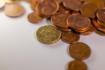 A pile of change on the table. Many euro coins in one stack. The concept of a monetary crisis in the country. Selective soft focus
