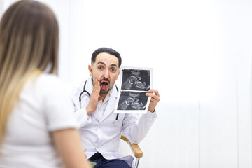 Photo of pregnant woman speaking with a doctor.