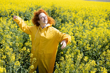 Fototapeta premium A woman dancing and singing in a field of flowers