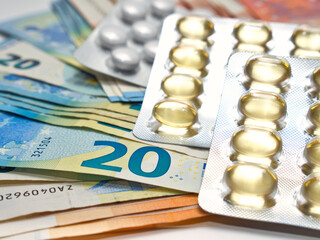Medication in a pack lying on a pile of euro bills