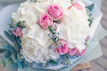 bouquet flowers background white hydrangea flowers and pink roses. texture, top view, close up. blooming flowers festive background, pastel and soft bouquet floral card