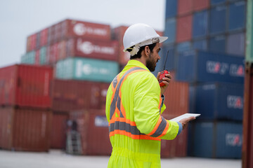 worker or engineer export management team inspecting containers To manage the export of goods to foreign countries Large cargo shipping, container yard.