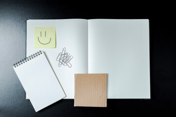 Open blank notebook with stationery accessories. Top view. Notepad. smile. Blank notebook concept. Smile concept.