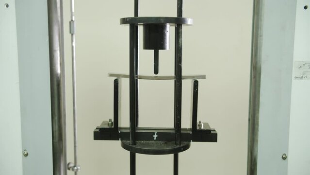 Sample of polycarbonate hollow sheet under laboratory press. Checking physical stability of plastic construction products in modern research laboratory