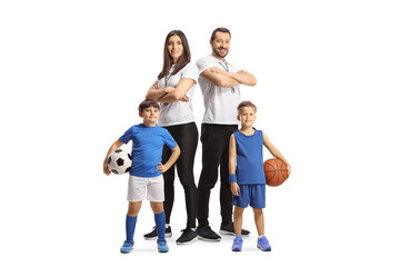 Fototapeta na wymiar Boys holding basketball and football in front of a male and female trainers