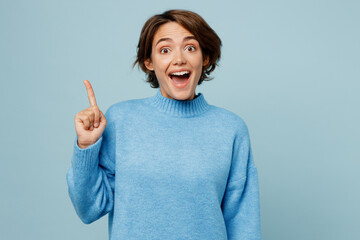 Young insighted smart proactive caucasian woman wear knitted sweater holding index finger up with...