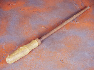 Old rusty round rasp with wooden handle on a grunge background