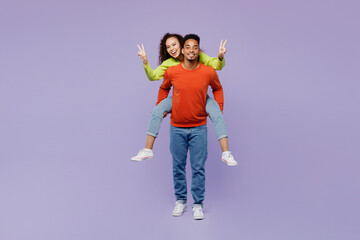 Full body young couple two friends family man woman of African American ethnicity wear casual...