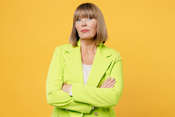 Elderly indignant sad mad woman 50s years old wearing green jacket white t-shirt holding hands...
