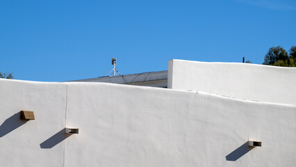 A wifi antenna on a white building