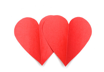 two love cutting red paper hearts on white